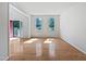 Bright, open-plan living room features hardwood flooring and an entrance with a red door at 3705 Cassaro Ln, Zebulon, NC 27597