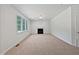 Spacious living room with a fireplace and large windows for natural light at 3705 Cassaro Ln, Zebulon, NC 27597