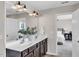 Well-lit bathroom featuring double vanity sinks, modern fixtures, and a doorway to the bedroom at 4024 Dunkirk Dr, Burlington, NC 27215