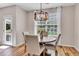 Cozy dining area with a rustic table set near a window, showcasing natural light and a view of the outdoors at 4024 Dunkirk Dr, Burlington, NC 27215