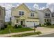 Charming yellow two-story home features a well-maintained lawn, a two-car garage, and inviting curb appeal at 4024 Dunkirk Dr, Burlington, NC 27215