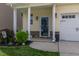 Inviting front porch features stone accents, decorative columns, and lush landscaping for welcoming curb appeal at 4024 Dunkirk Dr, Burlington, NC 27215