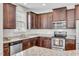 Spacious kitchen featuring granite countertops, stainless steel appliances, and dark wood cabinetry at 4024 Dunkirk Dr, Burlington, NC 27215