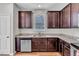 Kitchen with granite counters, stainless steel appliances, and dark wood cabinets, maximizing the space at 4024 Dunkirk Dr, Burlington, NC 27215