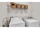 Clean laundry room with washer, dryer, storage shelves, and neutral colors at 4024 Dunkirk Dr, Burlington, NC 27215