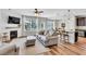 Open-concept living area with hardwood floors, fireplace, and large windows for plenty of natural light at 4024 Dunkirk Dr, Burlington, NC 27215