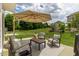 Inviting patio space complete with comfortable seating and an umbrella, ideal for outdoor relaxation and entertaining at 4024 Dunkirk Dr, Burlington, NC 27215