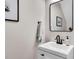 Stylish powder room featuring a modern vanity, black faucet, and framed artwork, creating an elegant space at 4024 Dunkirk Dr, Burlington, NC 27215