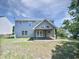 Two-story home with a patio, well-maintained lawn, and fenced yard at 4126 Amber Stone Way, Durham, NC 27704