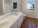 Clean bathroom featuring a double sink vanity, white fixtures, and wood-look flooring at 4126 Amber Stone Way, Durham, NC 27704