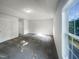 Bright, spacious bedroom with neutral walls, carpet flooring, and a large window at 4126 Amber Stone Way, Durham, NC 27704