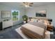 Bright bedroom featuring a ceiling fan, neutral walls, and large window at 4126 Amber Stone Way, Durham, NC 27704