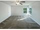 Spacious bedroom featuring two windows offering natural light and a ceiling fan at 4126 Amber Stone Way, Durham, NC 27704
