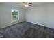 Bright bedroom with a ceiling fan, neutral walls, and large window at 4126 Amber Stone Way, Durham, NC 27704