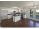 Updated kitchen with white cabinets, stainless steel appliances, and a center island for seating at 4126 Amber Stone Way, Durham, NC 27704