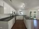 Well-lit kitchen featuring white cabinets, stainless steel appliances, and a center island at 4126 Amber Stone Way, Durham, NC 27704