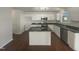 Modern kitchen with white cabinets, stainless steel appliances, and a large island at 4126 Amber Stone Way, Durham, NC 27704