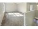 Large, bright room with a ceiling fan and carpet flooring at 4126 Amber Stone Way, Durham, NC 27704
