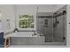 Modern bathroom featuring a soaking tub and a separate glass-enclosed shower with sleek fixtures at 4225 Old Lewis Farm Rd, Raleigh, NC 27604
