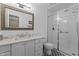 Beautiful bathroom with a glass shower, black and white tile floor, a marble counter, and a gold-framed mirror at 4225 Old Lewis Farm Rd, Raleigh, NC 27604