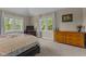 Bedroom with dual windows offering ample natural light and views of outdoor greenery at 4225 Old Lewis Farm Rd, Raleigh, NC 27604