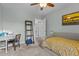 Bedroom featuring tan carpet, light green walls, a ceiling fan and desk area with modern artwork at 4225 Old Lewis Farm Rd, Raleigh, NC 27604