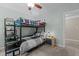 A cozy bedroom featuring a bunk bed, ceiling fan, and a view of backyard scenery at 4225 Old Lewis Farm Rd, Raleigh, NC 27604