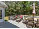Inviting deck area with cushioned seating and an umbrella overlooking beautiful mature trees at 4225 Old Lewis Farm Rd, Raleigh, NC 27604