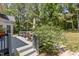 Wooden deck showcasing patio furniture, and a view of the lush backyard with mature trees at 4225 Old Lewis Farm Rd, Raleigh, NC 27604