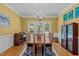 Elegant dining room with hardwood floors, chandelier, and abundant natural light at 4225 Old Lewis Farm Rd, Raleigh, NC 27604