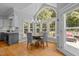 Bright dining area featuring hardwood floors, large windows, and a chandelier at 4225 Old Lewis Farm Rd, Raleigh, NC 27604