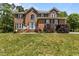 Charming brick home on a lush green lawn, showcasing its classic design and curb appeal at 4225 Old Lewis Farm Rd, Raleigh, NC 27604