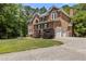 Classic brick two-story home with a three car garage, beautiful lawn and mature landscaping at 4225 Old Lewis Farm Rd, Raleigh, NC 27604