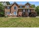 Stately brick home with a beautifully landscaped front yard and classic architectural details at 4225 Old Lewis Farm Rd, Raleigh, NC 27604