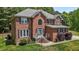 Classic brick home featuring a blue front door, lush landscaping, and welcoming curb appeal at 4225 Old Lewis Farm Rd, Raleigh, NC 27604