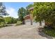Brick home featuring a spacious driveway leading to a two-car garage with white garage doors at 4225 Old Lewis Farm Rd, Raleigh, NC 27604