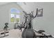 Bright gym features state-of-the-art equipment, neutral carpet, and an arched window at 4225 Old Lewis Farm Rd, Raleigh, NC 27604