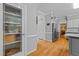 Hallway with hardwood floors leading to the kitchen and featuring a pantry door at 4225 Old Lewis Farm Rd, Raleigh, NC 27604