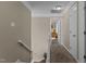Upstairs hallway featuring neutral walls and trim, leading to various rooms of the house at 4225 Old Lewis Farm Rd, Raleigh, NC 27604