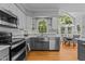 Bright kitchen featuring stainless steel appliances and a breakfast nook with large windows at 4225 Old Lewis Farm Rd, Raleigh, NC 27604