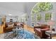 Bright living room with hardwood floors, large windows, and an open view to the kitchen at 4225 Old Lewis Farm Rd, Raleigh, NC 27604
