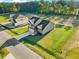 Aerial shot of a house with a green lawn and long driveway at 482 Olivia Crossing Ct, Four Oaks, NC 27524