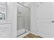 Modern bathroom featuring tiled shower with glass door, and wood look floor at 482 Olivia Crossing Ct, Four Oaks, NC 27524