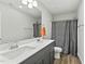 Bathroom featuring a double vanity, shower with curtain, and modern fixtures at 482 Olivia Crossing Ct, Four Oaks, NC 27524