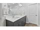 Double vanity with a white countertop and dark cabinets, offering ample storage in a bright, modern bathroom at 482 Olivia Crossing Ct, Four Oaks, NC 27524