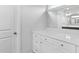 Modern bathroom features white vanity with plenty of storage and a sleek mirror at 482 Olivia Crossing Ct, Four Oaks, NC 27524