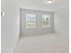 Bright bedroom featuring carpet floors, white walls, and windows with natural light at 482 Olivia Crossing Ct, Four Oaks, NC 27524