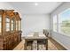 Bright dining area featuring a window and a modern table setting with seating for four, complete with a stylish rug at 482 Olivia Crossing Ct, Four Oaks, NC 27524
