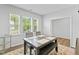 Bright dining area featuring three windows and a modern table setting with seating for four, complete with a stylish rug at 482 Olivia Crossing Ct, Four Oaks, NC 27524