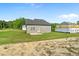 Exterior rear view of home with large yard and neighboring houses at 482 Olivia Crossing Ct, Four Oaks, NC 27524